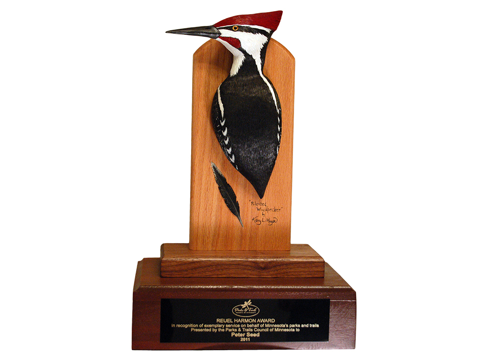 carving of a pileated woodpecker mounted on award