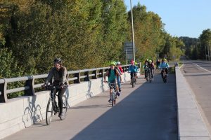 Kids bike over bridge on protected, separated bike path