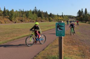 Kids biking on and off the trail