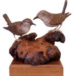 two carved wrens