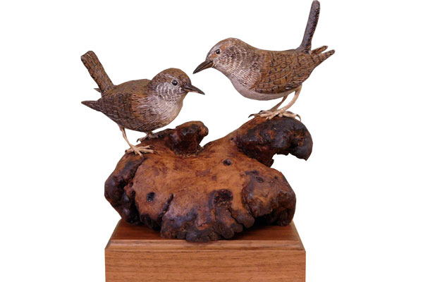 two carved wrens