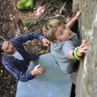 boy climbing on boulder at Banning