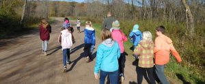 kids and naturalist walk along a gravel path
