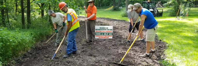 Volunteers raking dirt to restore prairie plants