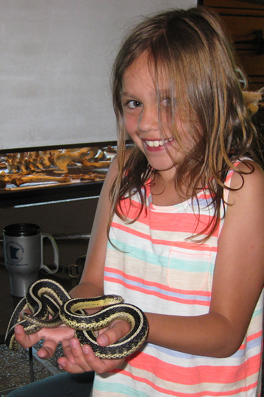 girl holding snake