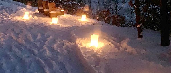 Candles along path in snow