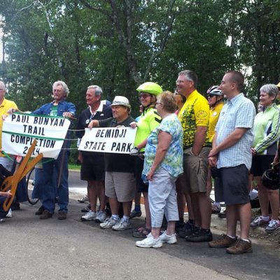 Group celebrating a ribbon cutting for the Paul Bunyan Trail