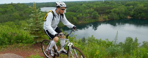 Mountain biker on trail overlooking lake