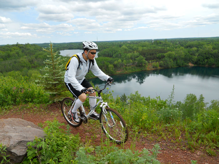 Mountain biker on trail overlooking lake