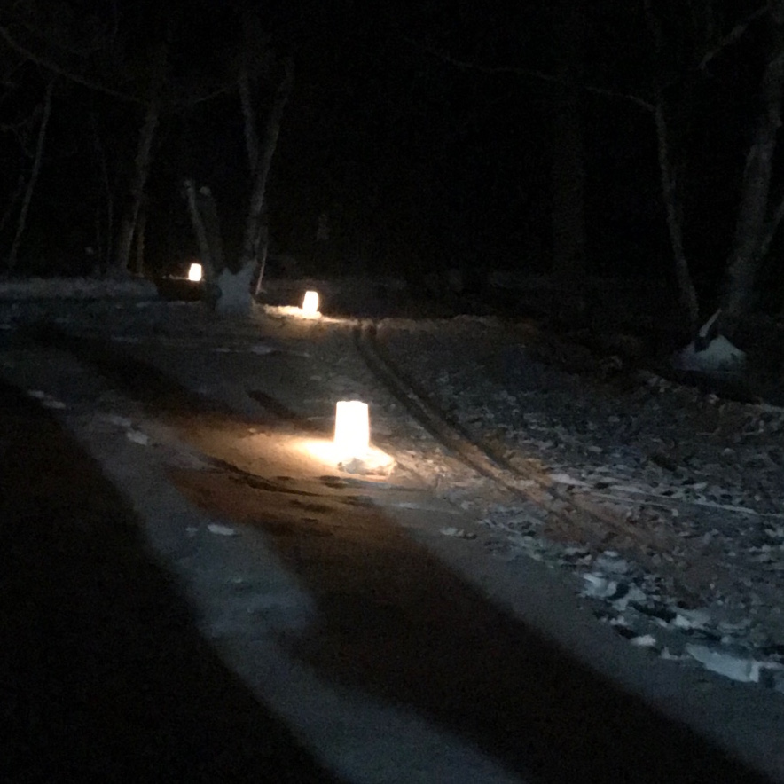candles lit along a ski trail