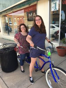 Two women on a tandem bicycle