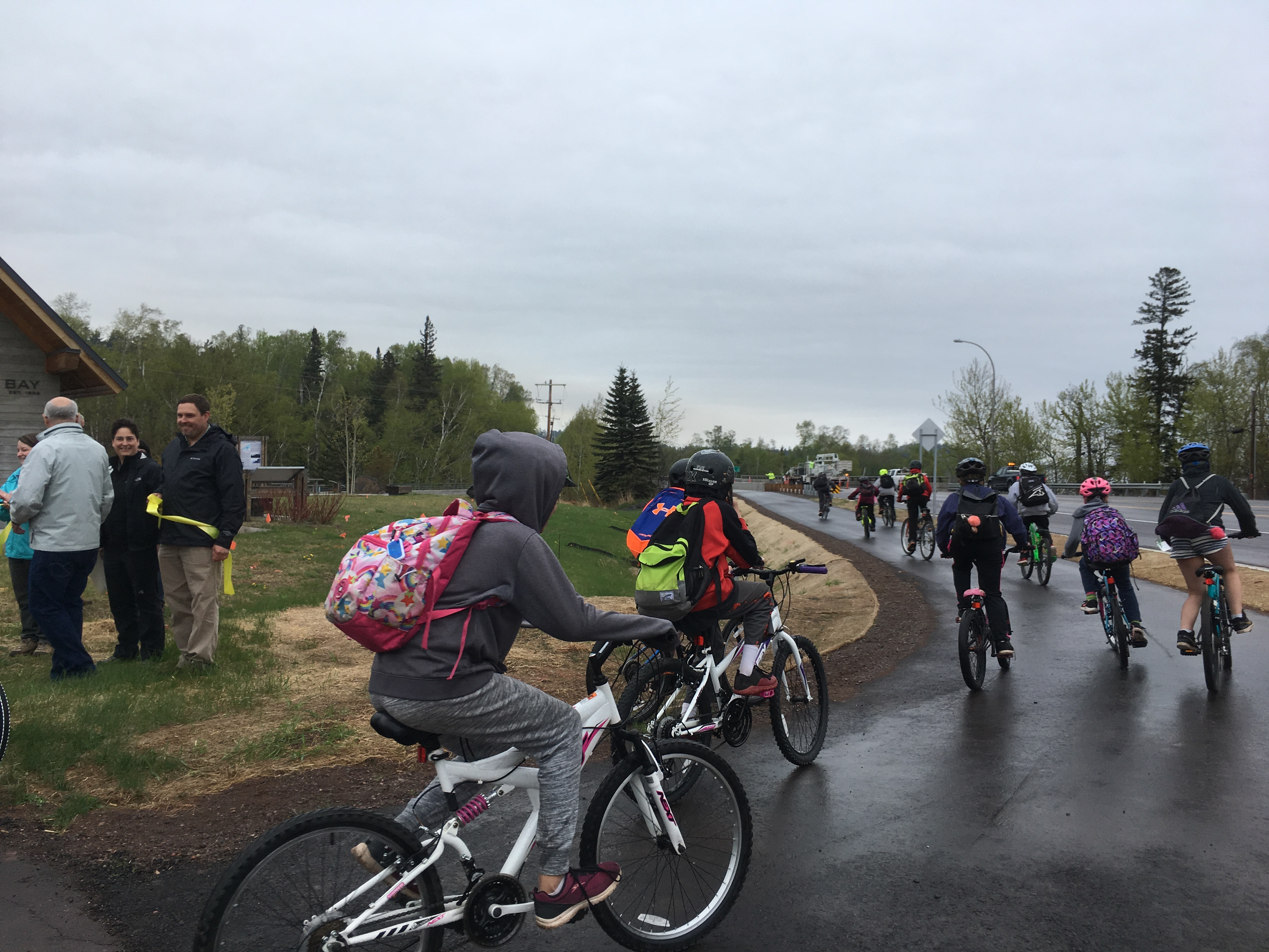 Kids take off by bike on the newly opened paved trail