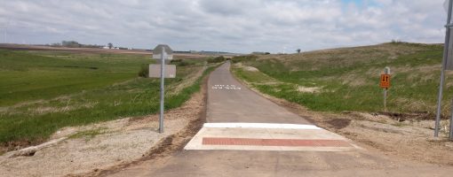 new paved trail segment with fields on each side