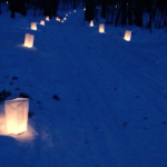 Luminaries light the ski trail