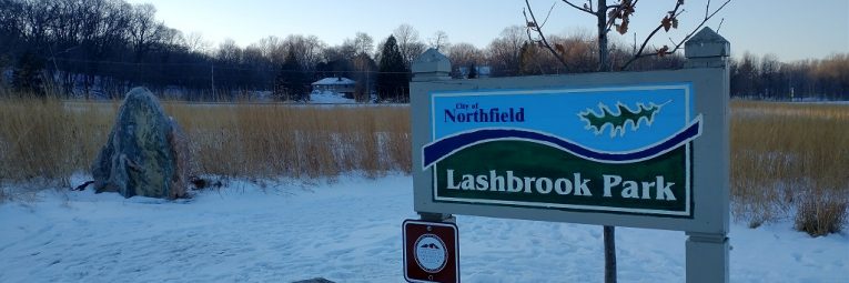 Lashbrook park sign with snow on the ground