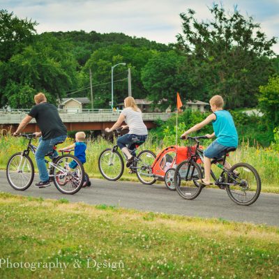 A family of bikers heads down the trail